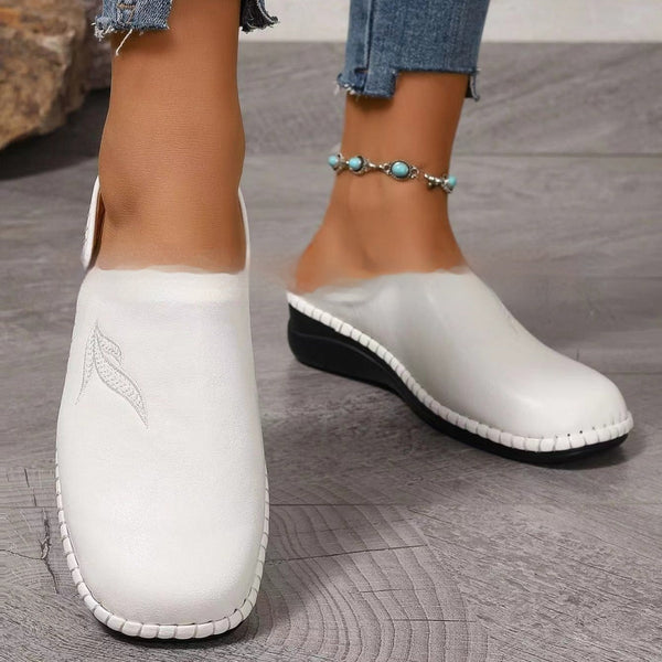 White round toe flat bottom slip-on loafers with minimalist design and stitching detail
