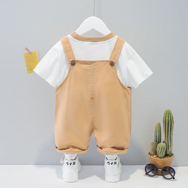 Children's cotton summer cartoon short-sleeved overall in khaki color with white t-shirt and sneakers on hanger.