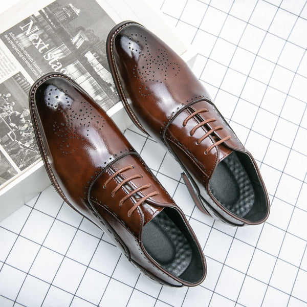 Brown men's business formal wear leather shoes with perforated design and low top style.